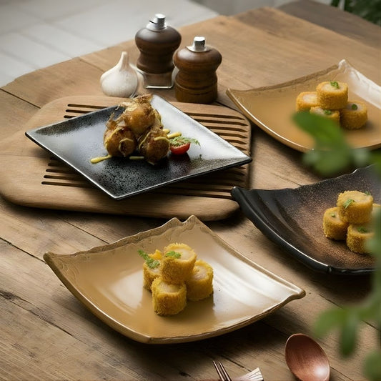 Plated dishes of food on a wooden table with a wooden spoon and fork.