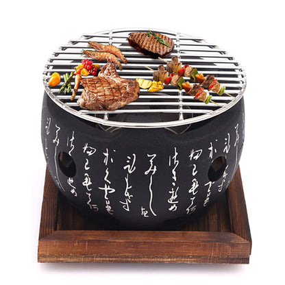 Black portable grill with food on a white background